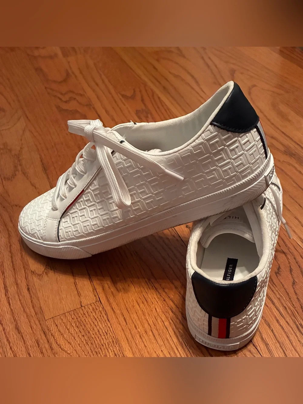 Tommy Hilfiger White Embossed Sneakers with Navy Heel and Red-White-Blue Stripe.